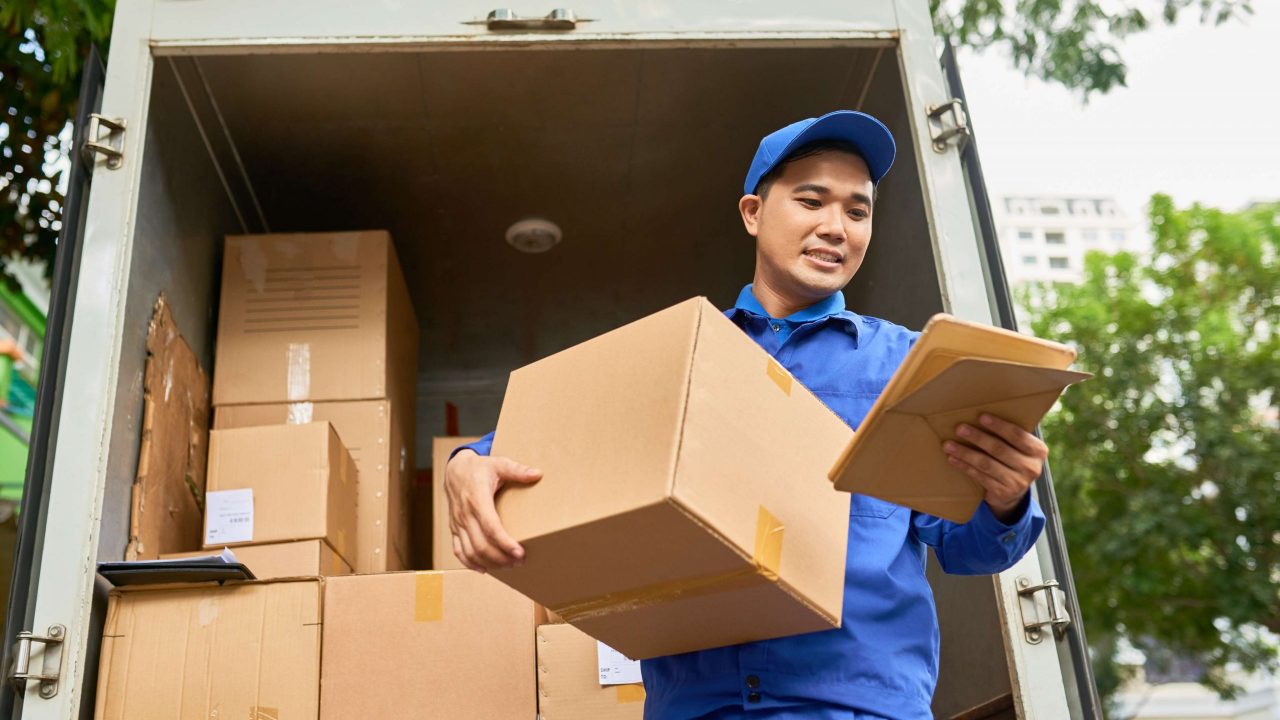 positive-young-asian-man-delivering-mail-checking-address-parcel-details-tablet-computer positive-young-asian-man-delivering-mail-checking-address-parcel-details-tablet-computer